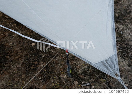 Early morning with frost on the tarp in the woods 104667433