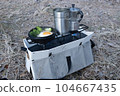 Scenery of cooking outdoors with a two-burner skillet and a cooker 104667435
