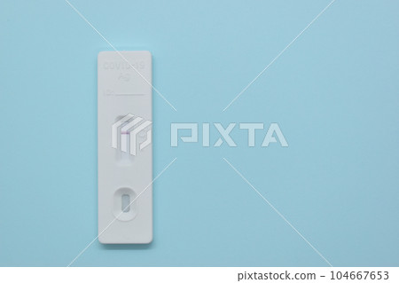 covid test kit on blue background covid test kit on blue background 104667653