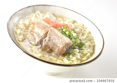 Piping hot Okinawa soba with pork belly, plenty of small green onions and red pickled ginger, photographed against a white background 104667938