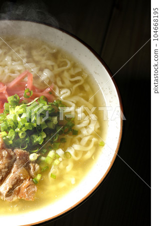 A bird's-eye view of hot Okinawa soba with pork ribs, plenty of small green onions, and pickled ginger 104668195