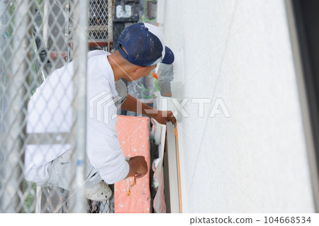 Scaffolding exterior wall painting 104668534