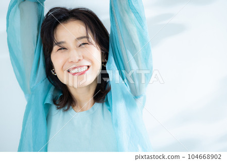 middle lady in aqua blue shirt 104668902