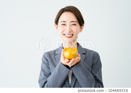 A young woman holding a piggy bank Business image 104669358