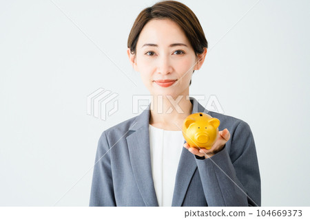 A young woman holding a piggy bank Business image 104669373