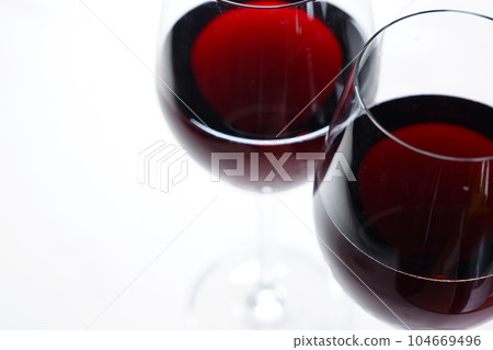 Two wine glasses filled with red wine Two wine glasses filled with red wine 104669496