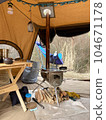 Wood stove, firewood and wood table in the tent 104671178