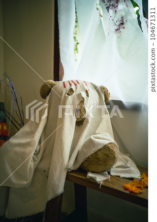 Halloween decorations background. Halloween Scary with Cute teddy bear.Ghost on wooden table Halloween holiday concept. Halloween decorations background. Halloween Scary with Cute teddy bear.Ghost on wooden table Halloween holiday concept. 104671311