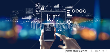 NFT theme with person using a smartphone at night 104671998