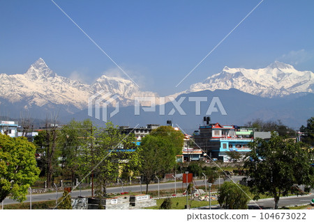 View of the Himalayas Machhapuchare and the Annapurna range from the Pokhara Airport building, Nepal in South Asia View of the Himalayas Machhapuchare and the Annapurna range from the Pokhara Airport building, Nepal in South Asia 104673022