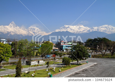 View of the Himalayas Machhapuchare and the Annapurna range from the Pokhara Airport building, Nepal in South Asia View of the Himalayas Machhapuchare and the Annapurna range from the Pokhara Airport building, Nepal in South Asia 104673024