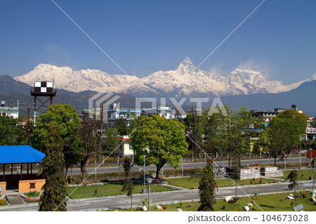 View of the Himalayas Machhapuchare and the Annapurna range from the Pokhara Airport building, Nepal in South Asia View of the Himalayas Machhapuchare and the Annapurna range from the Pokhara Airport building, Nepal in South Asia 104673028