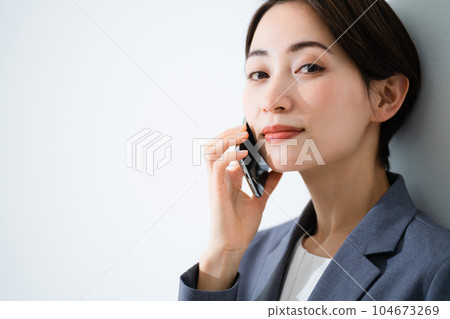 Young woman talking on smartphone business image 104673269