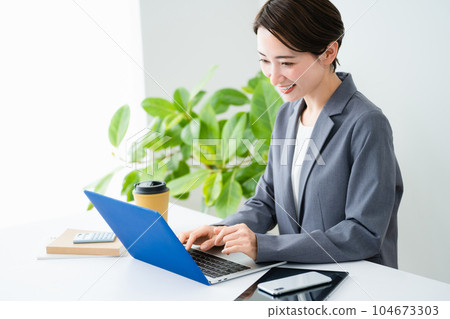 A young woman who is pleased with her achievements Business image A young woman who is pleased with her achievements Business image 104673303