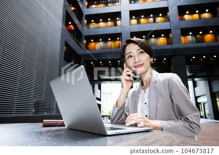 Woman, business, computer, smartphone, smile, call Woman, business, computer, smartphone, smile, call 104673817