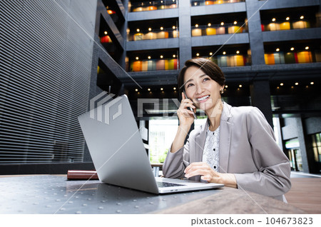Female business computer smartphone smile call 104673823