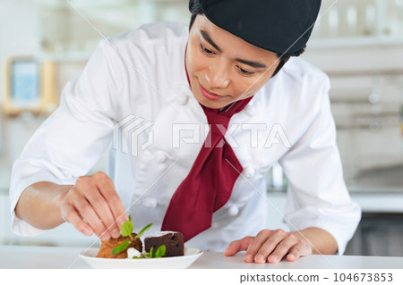 Pastry chef serving dessert Pastry chef serving dessert 104673853