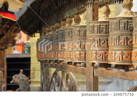 Nepal's world cultural heritage Kathmandu Valley Prayer wheel of Tibetan Buddhist temple Swayambhunath on the hill Nepal's world cultural heritage Kathmandu Valley Prayer wheel of Tibetan Buddhist temple Swayambhunath on the hill 104675730