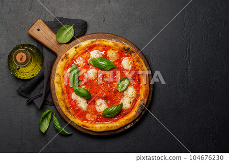 Margarita pizza with tomatoes, mozzarella cheese and basil Margarita pizza with tomatoes, mozzarella cheese and basil 104676230
