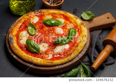 Margarita pizza with tomatoes, mozzarella cheese and basil Margarita pizza with tomatoes, mozzarella cheese and basil 104676232