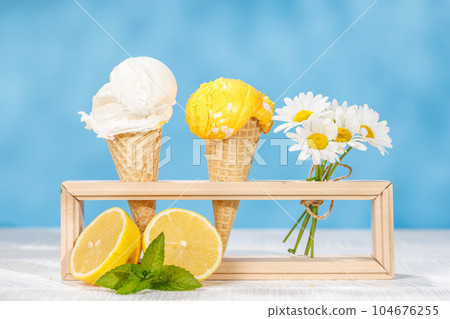 Refreshing ice cream in waffle cones with lemon flavour Refreshing ice cream in waffle cones with lemon flavour 104676255