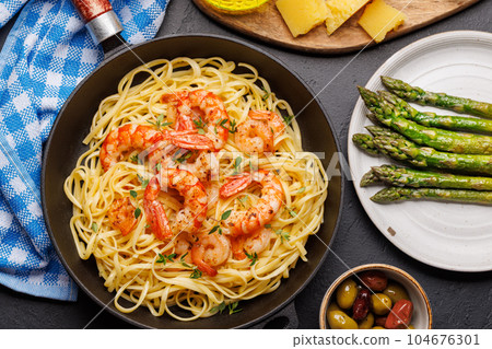 A delightful Italian pasta adorned with shrimps 104676301
