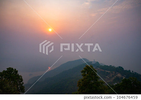 A landscape of World Peace Pagoda or Pokhara Shanti Stupa, a Buddhist monument on Anadu Hill, Pokhara, Nepal 104676459