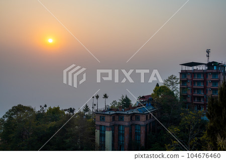 A landscape around Nargakot village at sunrise on a foggy day. Nargakot located at the rim of the Kathmandu Valley. It's known for its views of the Himalayas, including Mount Everest 104676460