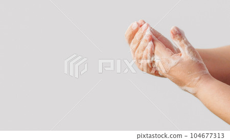 Antibacterial hygiene. Virus prevention. Woman cleansing hands skin with sanitizing soap foam washing off bacteria isolated on white background empty space. 104677313