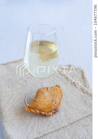 Torta de Guimaraes with glass of wine Torta de Guimaraes with glass of wine 104677396