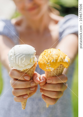Refreshing ice cream in waffle cones with lemon flavour Refreshing ice cream in waffle cones with lemon flavour 104677606