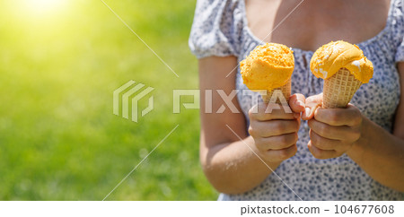 Refreshing ice cream in waffle cones with lemon flavour 104677608