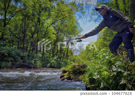 Mountain stream fishing 104677828