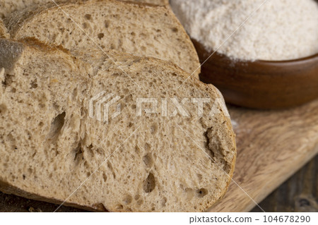 A loaf of bread made of wheat and rye flour cut into pieces A loaf of bread made of wheat and rye flour cut into pieces 104678290