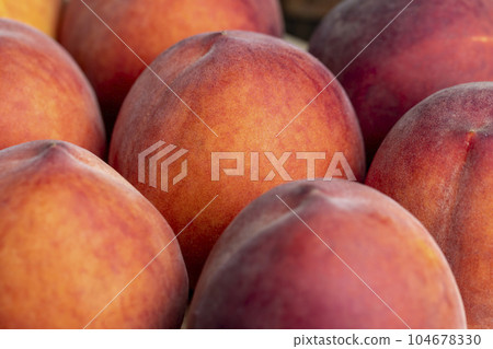 Ripe fresh peaches on a wooden table Ripe fresh peaches on a wooden table 104678330