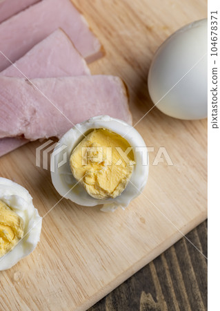Boiled chicken egg with sliced pieces of meat Boiled chicken egg with sliced pieces of meat 104678371