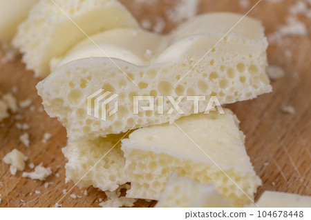 White Chocolate Bar with bubbles close-up White Chocolate Bar with bubbles close-up 104678448