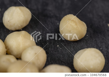 Peeled macadamia nuts on the table 104678568
