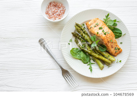 Baked Delicious salmon, green asparagus on  plate 104678569
