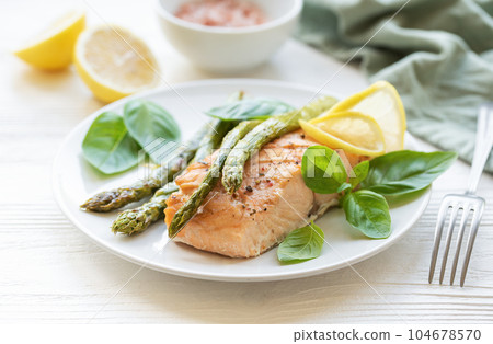 Baked Delicious salmon, green asparagus on  plate 104678570