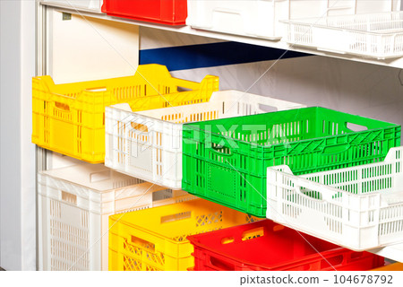 Containers colored plastic boxes on a warehouse shelf. Containers colored plastic boxes on a warehouse shelf. 104678792