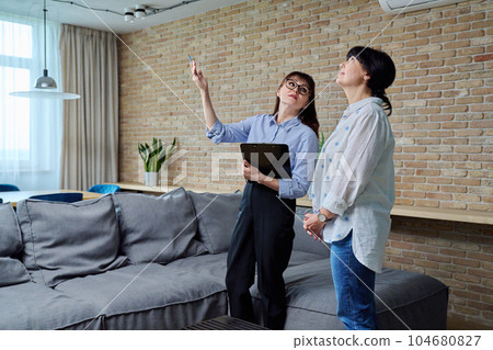 Female real estate agent showing apartment, house, to buyer, tenant Female real estate agent showing apartment, house, to buyer, tenant 104680827