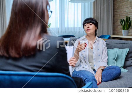 Mature woman at therapy meeting with psychologist 104680836
