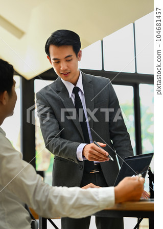 Shot of businessman explaining information, talking about company strategy and business plan during meeting Shot of businessman explaining information, talking about company strategy and business plan during meeting 104681457