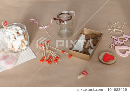 sweet gift for Valentine's Day with your own hands. A gift for the holiday made of heart-shaped candies and marshmallows 104682436