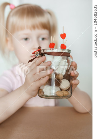 A little girl blogger makes a sweet Valentine's Day gift with her own hands. A gift for the holiday, a video blog entry. A little girl blogger makes a sweet Valentine's Day gift with her own hands. A gift for the holiday, a video blog entry. 104682635