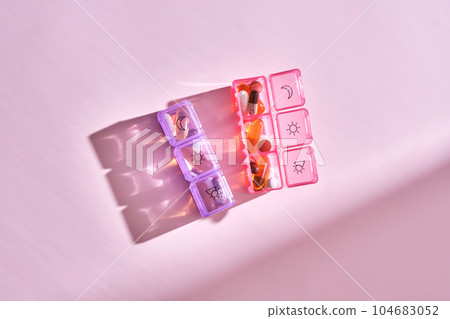 Bright pill box with different pills and vitamins. 104683052