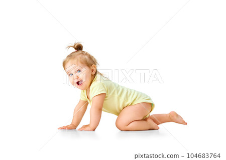 Cheerful, joyful, happy little baby, girl, toddler crawling and laughing against white studio background. Curious child Cheerful, joyful, happy little baby, girl, toddler crawling and laughing against white studio background. Curious child 104683764