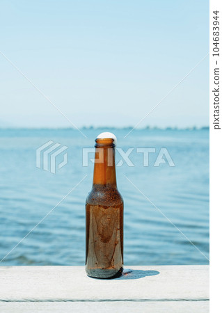 open beer bottle on a pier 104683944