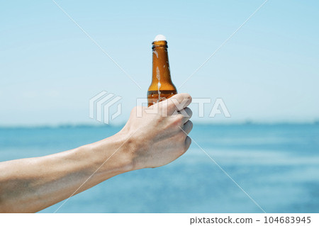 man with a refreshing beer bottle in his hand 104683945
